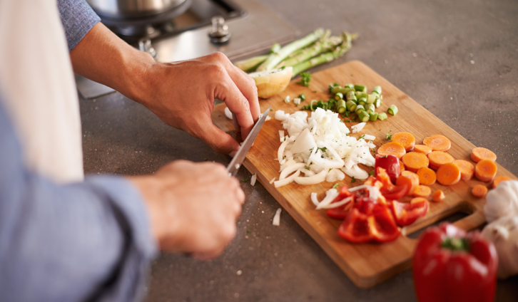 A person cutting vegetables on a cutting board